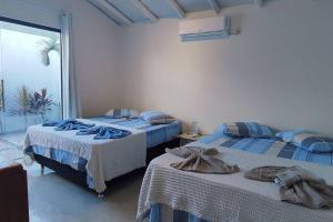Postel nebo postele na pokoji v ubytování Casa Azul, pertinho do mar