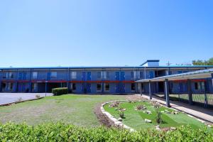 a building with a garden in front of it at Express Inn in Durant