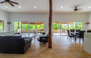 a living room with couches and a table and chairs at Hotel & Suites Oasis Bacalar in Bacalar