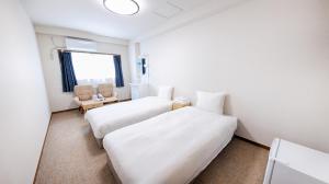 Postel nebo postele na pokoji v ubytování Ayanishiki大阪西九条STAY