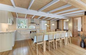a kitchen and dining room with a table and chairs at Jægerstuen in Bedegård