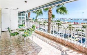 a balcony with a table and chairs and a view of the ocean at Nice Apartment In Santa Pola in Santa Pola