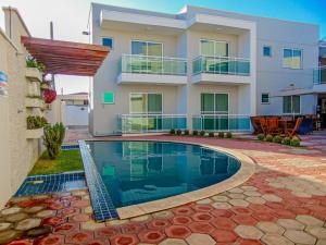 a house with a swimming pool in front of it at Terraço Hotel Lagoinha in Lagoinha