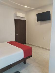 a bedroom with a bed and a television on the wall at Hotel Cermar Plaza in La Barca +53 photos