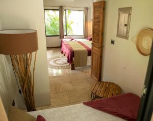 Postel nebo postele na pokoji v ubytování LA QUEBRADA ECO LODGE Hotel Boutique