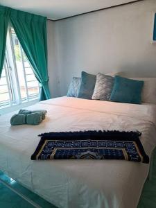 a bedroom with a large bed with a large window at Lumayan Guesthouse, Pantai Murni in Yan +11 photos