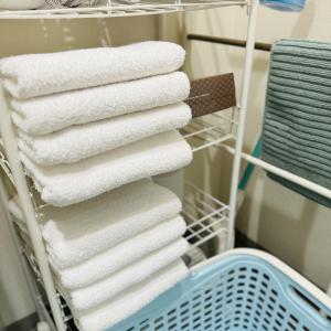 a stack of towels on a towel rack in a bathroom at Thanyaporn Hotel in Takayama +82 photos