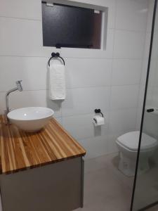 a bathroom with a sink and a toilet at Pé na areia, casa na praia de frente para o mar in Florianópolis