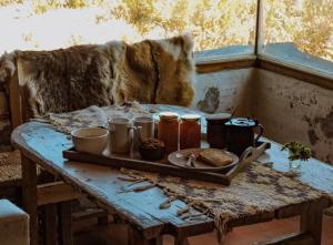 a table with a tray of food on top at Refugio Inka in Los Molles