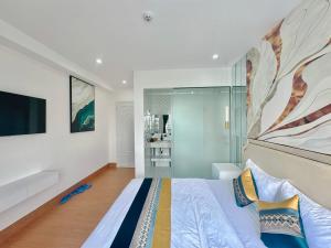 a bedroom with a bed and a large painting on the wall at Sky Star 3 Hotel in Can Tho