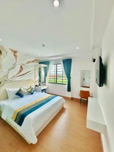 a bedroom with a large bed with blue curtains at Sky Star 3 Hotel in Can Tho