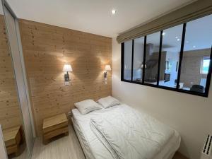 a small bedroom with a bed and a window at Appartement cosy 6 couchages, accès pistes, parking - FR-1-787-1 in Saint-Jacques-des-Blats +3 photos