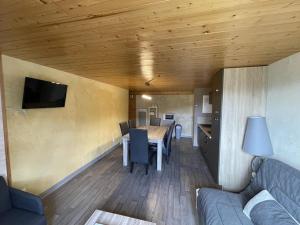 a living room with a table and a couch at Beau duplex 6 pers. à 200m des pistes, parking gratuit - FR-1-787-11 in Saint-Jacques-des-Blats