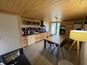a kitchen with a wooden ceiling and a wooden table at Bel appartement duplex proche des pistes avec balcon et parking - FR-1-787-16 in Saint-Jacques-des-Blats