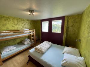 a room with two bunk beds and a window at Appartement spacieux avec animaux admis et parking gratuit - FR-1-787-18 in Saint-Jacques-des-Blats