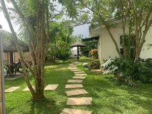 a stepping stone path in a yard next to a house at Romantic Cabin Retreat with Garden View and Free Parking in Amadeo