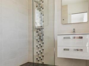 a bathroom with a shower with a sink and a mirror at Maison neuve au calme avec jardin clos, proche plage, port et équipements familiaux - FR-1-306-1274 in La Turballe