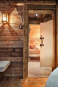 an open door into a room with wooden walls at Chalet Promi-Alm in Flachau in Flachau