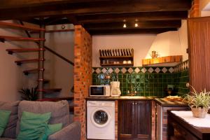 a kitchen with a washing machine in a room at El Requexu, apartamentos a 900 m de la playa de Poo AR-0474-AS in Llanes