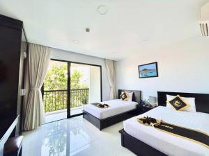 Postel nebo postele na pokoji v ubytování Hoang Long Hotel Phan Thiết