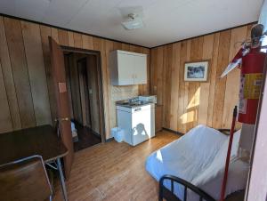 una camera con cucina con letto e tavolo di Tiny Wood Cottage 16 a Wasaga Beach