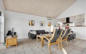 a living room with a table and chairs and a couch at Holiday Home Pengeurtvej Vordingborg V in Vordingborg