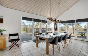 a dining room with a table and chairs at Holiday Home Pengeurtvej Vordingborg V in Vordingborg