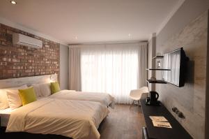 um quarto de hotel com uma cama e uma televisão em Swakopmund Plaza Hotel em Swakopmund