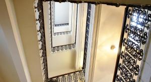 a mirror with a black and white patterned frame at HPA Hotel Andreas in Vienna