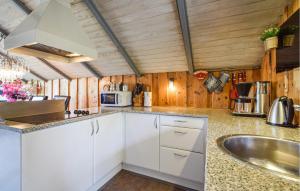 a kitchen with white cabinets and a sink at Holiday Home Silkeborg With A Fireplace 05 in Funder Kirkeby