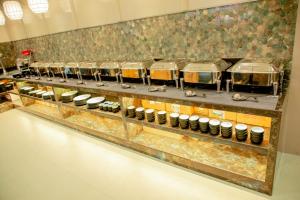 a kitchen with a row of pots and pans at Narayani Executive in Tuljapur