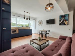 a living room with a couch and a table at Anto Apartments in Râşnov