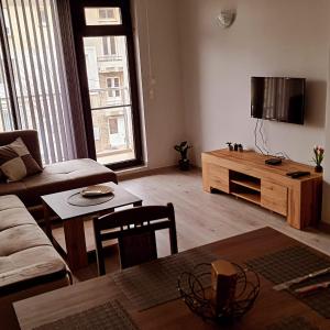 a living room with a couch and a table at Апартаменти за Гости ИвАя Казанлък in Kazanlŭk +37 photos