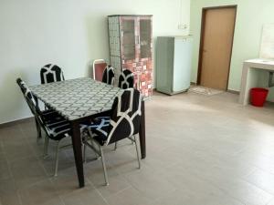 a dining room with a table and chairs at Panorama Homestay in Jeram