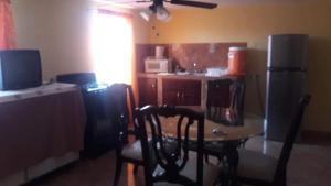 a kitchen with a table and chairs in a room at Apartamento División del Norte Planta Alta in Matamoros