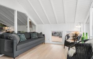 a living room with a couch and a dog at Three-Bedroom Holiday Home In Ringkobing in Ringkøbing