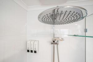 Port AdelaideBeach Stayz Semaphore Three Bedroom Apartment的浴室设有带玻璃淋浴头的淋浴