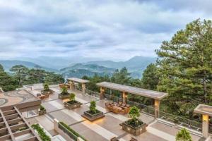 an aerial view of a building with mountains in the background at Baguio Bliss Suites in Baguio