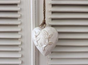 a white heart hanging on a house door at Le Clos du Plantis in Sonnac +27 photos