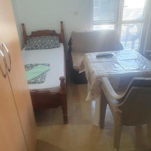 a small room with a bed and a table at Apartmani Lalo Jankovic in Sutomore +26 photos