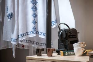 a table with cups and a bag on it at King's Blue , Superior Living in Heraklio Town +9 photos