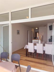 a dining room with white chairs and a table at Prizba Tomas One in Blato +22 photos