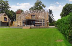 a wooden house with a lawn in front of it at Haus 3 in Wendorf