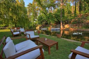 a yard with chairs and a table and a pond at Dalya Life in Göcek