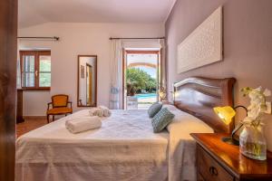 a bedroom with a large white bed and a window at Agri Resort San Giuliano in Santa Maria la Palma +181 photos