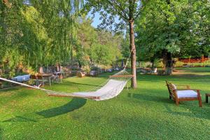 a hammock in a park with tables and benches at Dalya Life in Göcek