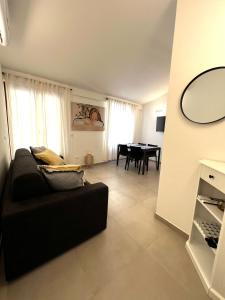 a living room with a black couch and a table at Casa Camilla in Riomaggiore