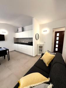 a living room with a black couch and a table at Casa Camilla in Riomaggiore