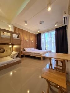 a room with two beds and a table and benches at De Chalet in Bangkok +39 photos