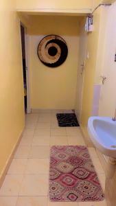a bathroom with a sink and a toilet and a rug at 7 Mogotio in Nairobi